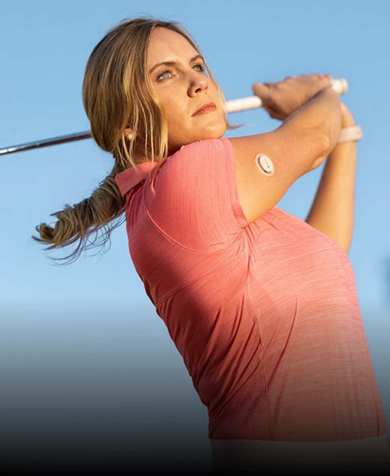 A woman playing golf wearing a Dexcom G7 sensor
